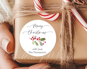 May include: A wrapped gift with a round sticker that reads "Merry Christmas" with a floral design. The gift is tied with twine and a candy cane is placed on top. The sticker also says "with love, The Thompsons."
