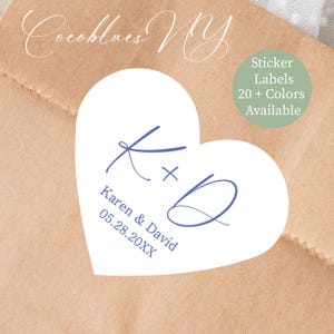 May include: A white heart-shaped sticker with blue calligraphy initials and names, "Karen & David" and a date. The sticker is on a brown paper background. Text on the right says "Sticker Labels 20+ Colors Available."