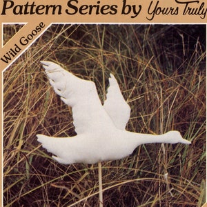 May include: A white fabric wild goose weathervane pattern. The pattern is available in four sizes: Extra Small (7 1/2 inches by 6 inches), Small (9 1/2 inches by 8 inches), Medium (12 1/2 inches by 10 inches), and Large (17 1/2 inches by 14 inches).