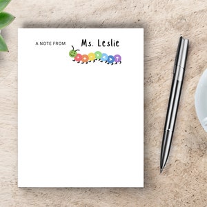 May include: A white notepad with a colorful caterpillar illustration and the text "A note from Ms. Leslie".