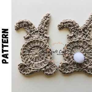 May include: Two crocheted bunny shapes in beige with white pom-poms. The bunnies are made with a textured stitch and have long ears. Digital Crochet Pattern.