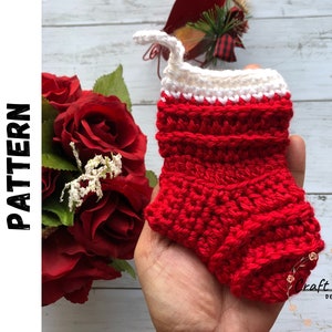 May include: Red and white crocheted stocking with a white cuff. The stocking is held in a hand. The image is labeled "Digital Crochet Pattern".