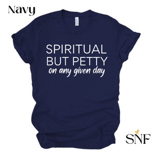 May include: Navy blue t-shirt with white text that reads "Spiritual but Petty on any given day".