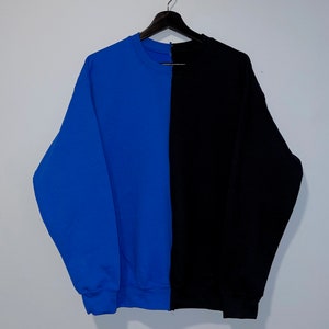 May include: A blue and black sweatshirt with a vertical seam down the center.