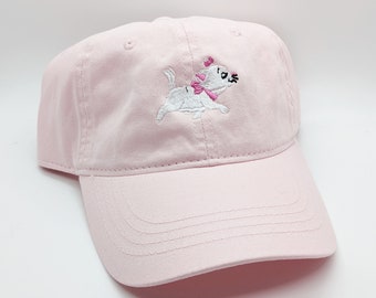 May include: A pink baseball cap with a white embroidered image of a cat wearing a pink bow.