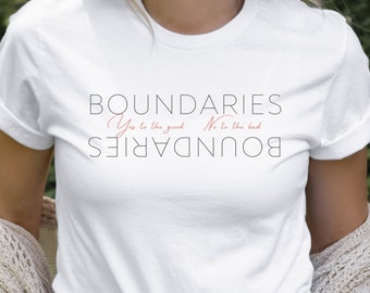 May include: White t-shirt with the text "BOUNDARIES" printed in black. The text "Yes to the good" and "No to the bad" are printed in pink below the word "BOUNDARIES".