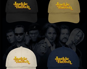 May include: Four baseball caps with the text "Jackie Brown" in a retro font. The caps are in black, khaki, white, and navy blue.