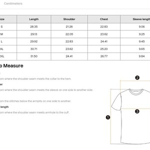 May include: A size chart for a t-shirt with columns for length, shoulder, chest, and sleeve length in inches for sizes S through 2XL. Below the table, a diagram illustrates how to measure these specific areas on a t-shirt using numbered labels.