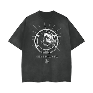 May include: Black t-shirt with a white graphic of a face inside a circle with the text "HEVEDILVKA" underneath.