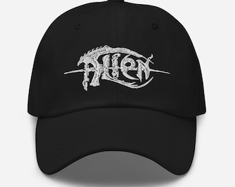 May include: Black baseball cap with a white embroidered alien logo. The logo is a stylized alien creature with the word "Alien" written in a gothic font.