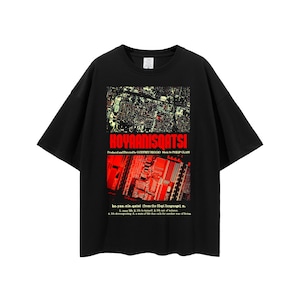 May include: Black t-shirt with a red and white graphic print of a city skyline and the text "KOYAANISQATSI". The text below the graphic reads "ko.yan.nis.qatsi (from the Hopi language), n. 1. crazy life. 2. life to turmoil. 3. life out of balance. 4. life disintegrating. A state of life that calls for another way of living."