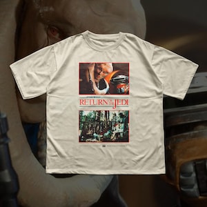 May include: Off-white t-shirt featuring a Star Wars: Return of the Jedi graphic. The graphic includes images of characters and scenes from the film, with the movie title in red and white text.