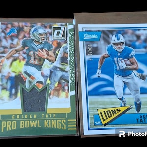 May include: Two Golden Tate football trading cards. One card is a Donruss Pro Bowl Kings card with a green and gold design. The other is a Classics card with a blue and white design. Both cards feature Golden Tate in a Detroit Lions uniform.
