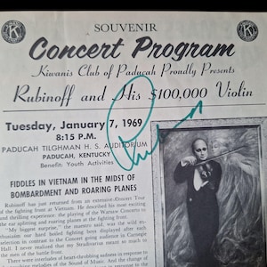 May include: A vintage concert program souvenir from 1969, featuring "Rubinoff and His $100,000 Violin." The black and white image includes text and a portrait of a violinist. The program is from the Kiwanis Club of Paducah.