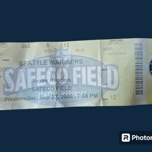 May include: A yellow ticket for a Seattle Mariners baseball game at Safeco Field against the Texas Rangers on Wednesday, September 27, 2000 at 7:05 PM. The ticket is for seat 12 in row 9, aisle 383. The ticket cost $9.00.