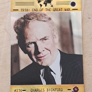 May include: A trading card featuring a portrait of Charles Bickford. The card has a gold border with the text "1918: END OF THE GREAT WAR" and a world map graphic. The card also includes the text "#216 - CHARLES BICKFORD".