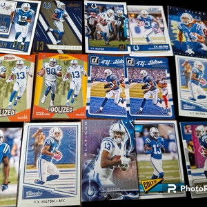 May include: A collection of trading cards featuring a football player wearing a blue and white uniform. The cards are from different sets and feature different images of the player. The cards are all in good condition and would be a great addition to any sports card collection.