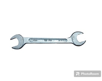 May include: A silver wrench with a 15 mm opening. The wrench has the text "15 mm" and "Made in Germany" printed on it.