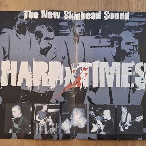 May include: A black and white poster with the text "The New Skinhead Sound" and "HARD TIMES" in large, bold letters. The poster features images of band members and a splattered red design element.