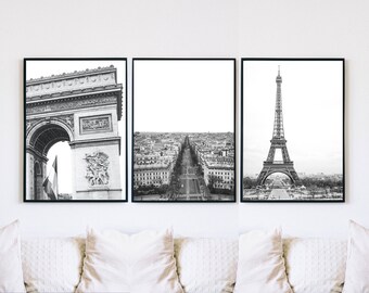 May include: A set of three black and white framed prints featuring iconic Parisian landmarks: the Arc de Triomphe, a street view of the Champs-Élysées, and the Eiffel Tower.