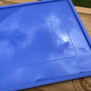 May include: A blue silicone baking mat with three square outlines, labeled "141", "1301", and "13C".
