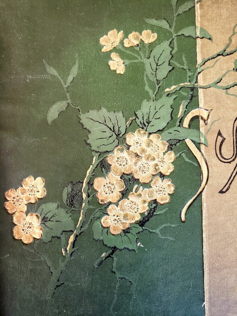 May include: A green background with a gold floral design. The flowers are delicate and have a vintage feel. The design is reminiscent of a book cover or a decorative piece.