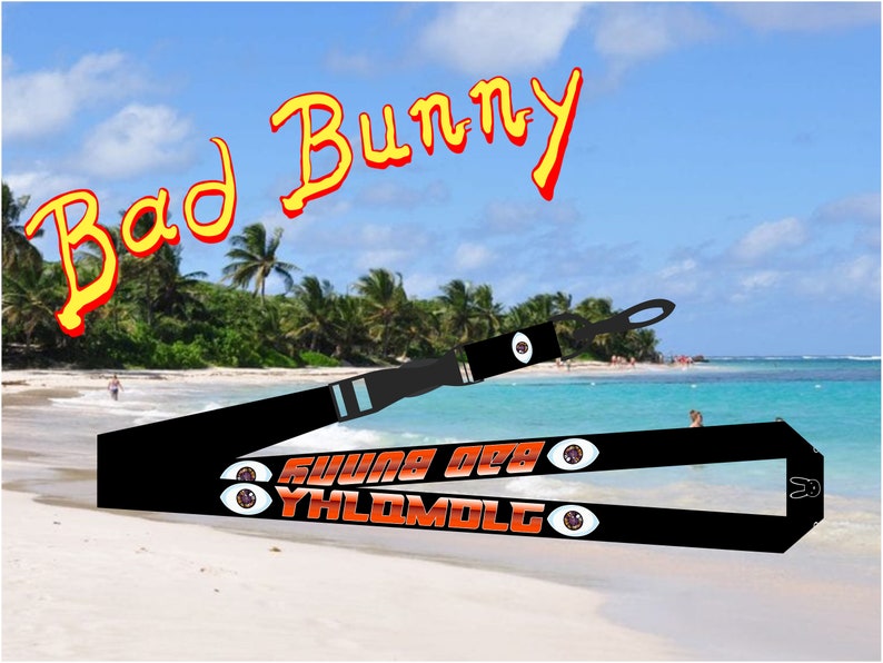 May include: Black lanyard with the text "YHLQMDLG" and "X100TO" in orange with a red eye graphic on each side. The lanyard is on a beach with a blue sky and palm trees in the background. The text "Bad Bunny" is written in yellow and red at the top of the image.