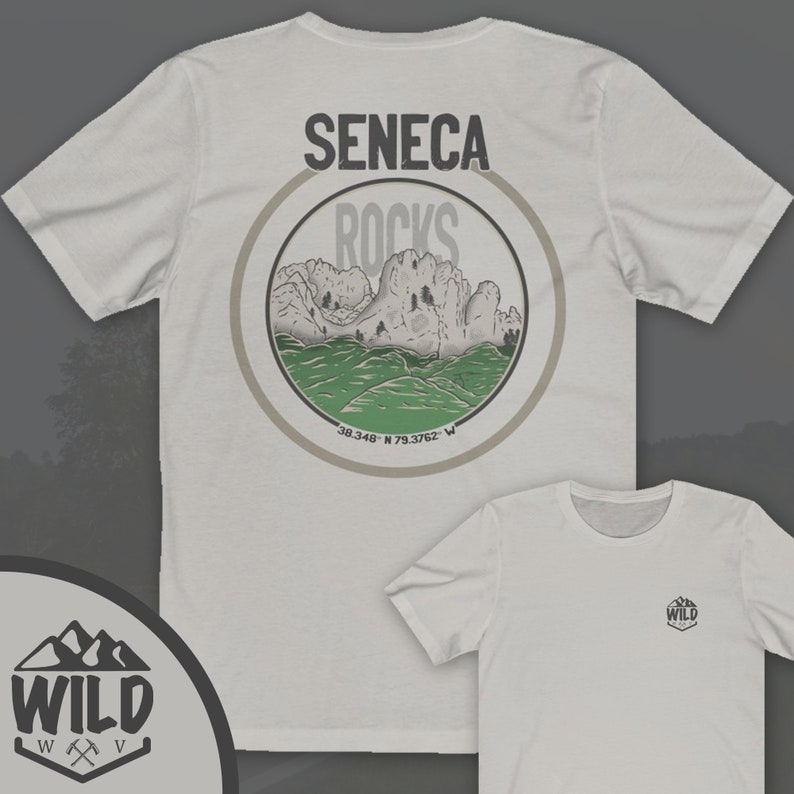 May include: White t-shirt with a circular graphic on the back. The graphic features a mountain range with the text "Seneca Rocks" and coordinates "38.348&deg; N 79.3762&deg; W". The front of the shirt has a small logo with the text "WILD" and a mountain range graphic.