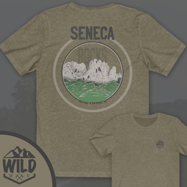 May include: A green and brown t-shirt with a graphic of Seneca Rocks, a mountain range in West Virginia. The graphic is in a circle with the text "Seneca Rocks" and coordinates "38.348 N 79.3762 W". The t-shirt has a small logo on the front that says "Wild" with a mountain range and an axe.