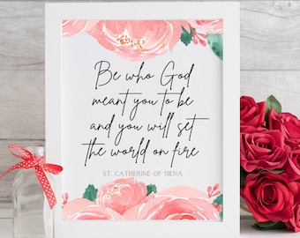 May include: White framed print with a pink floral design and a quote from St. Catherine of Siena: "Be who God meant you to be and you will set the world on fire."