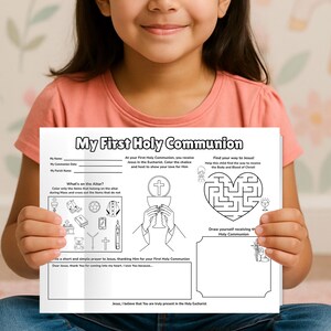 Op de afbeelding: Een jong meisje houdt een zwart-wit werkblad vast met de titel "Mijn Eerste Heilige Communie". Het blad bevat invulvelden, religieuze illustraties, een doolhof en een tekenruimte. Het meisje draagt een roze T-shirt.