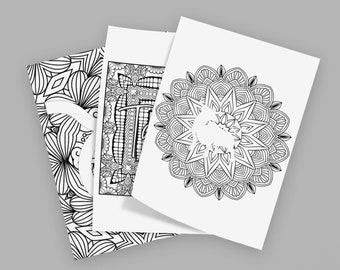 May include: Three rectangular sheets of white paper featuring black ink line art designs. The top sheet displays a circular mandala pattern with a silhouette of a bull in the center. The other sheets show intricate geometric and floral patterns.