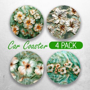 May include: Set of four round car coasters featuring a white floral design on a green background. The coasters have a 4 PACK label.
