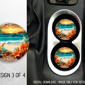 May include: Two round car coasters with a tropical beach sunset scene. The coasters feature a sandy beach, turquoise ocean waves, palm trees, and orange flowers. The coasters are in a car cup holder.