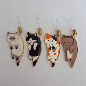 May include: Four cat-shaped charms with gold-colored metal accents. Each charm features a different cat design: Siamese, tuxedo, calico, and tabby. The charms have a small loop and string for attachment.