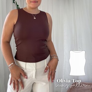 May include: A sleeveless, dark brown top with a round neckline. The top is paired with white pinstripe pants. The image also includes a line drawing of the top and the text "Olivia Top sewiz pattern".