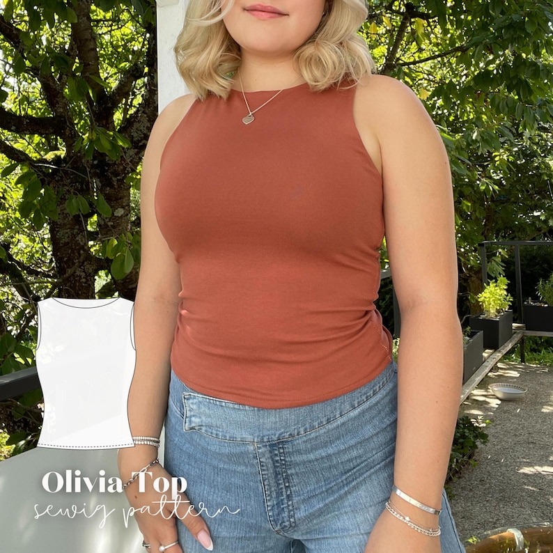 May include: A rust-colored tank top with a high neckline is worn with blue denim jeans. The image includes a white line drawing of the tank top and the text "Olivia Top sewing pattern". The top is form-fitting and appears to be made of a soft material.