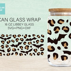 May include: A 16 ounce glass jar with a leopard print and bat design. The jar has a wooden lid. CAN GLASS WRAP 16 OZ LIBBEY GLASS SVG PNG DXF