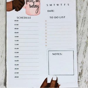 May include: A white dry-erase board with a daily schedule, to-do list, and notes section. The board has a pink mug with the text "focus on today" and a hand holding the mug.