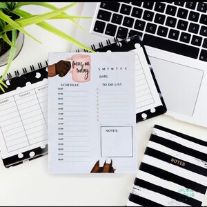 May include: A black and white polka dot planner with a daily schedule and to-do list. The planner has a pink mug with the text "focus on today" on it.