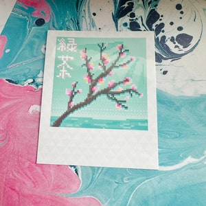 May include: A pixelated image of a cherry blossom tree with pink flowers on a light blue background. The text "桜の木" is written in Japanese on the left side of the image.