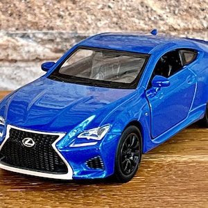 May include: A blue toy car model of a Lexus RC F, a sports coupe with a black grille and black wheels.