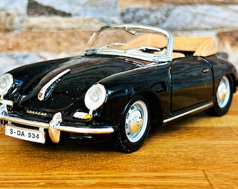 May include: Black convertible model car with a tan interior and a license plate that reads "S-DA 534".
