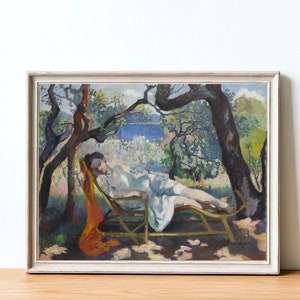 May include: A painting of a woman reclining on a chaise lounge in a garden setting. The woman is wearing a white dress and has her hair pulled back. The garden is lush and green, with trees and flowers. The painting is done in a style reminiscent of Impressionism, with loose brushstrokes and vibrant colors.
