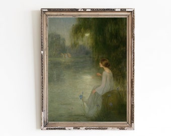 May include: A framed painting depicting a woman in a blue dress seated by a lake. The woman gazes out at the water, with trees and flowers in the background. The painting is executed in a soft, Impressionistic style.