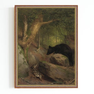May include: A framed oil painting depicting a black bear standing on a rock in a forest setting. The bear is looking down at a small rabbit sitting on the ground. The painting is set against a backdrop of green trees and foliage.