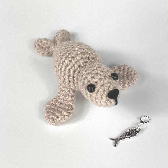 Amigurumi Harp Seal Kit. A full kit with luxury yarns and fittings plus a silver fish stitch-marker.