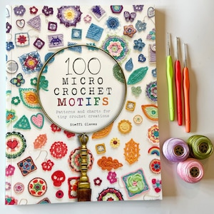 May include: A book titled "100 Micro Crochet Motifs: Patterns and charts for tiny crochet creations" by Steffl Glaves. The cover features a magnifying glass over a colourful array of crocheted motifs.