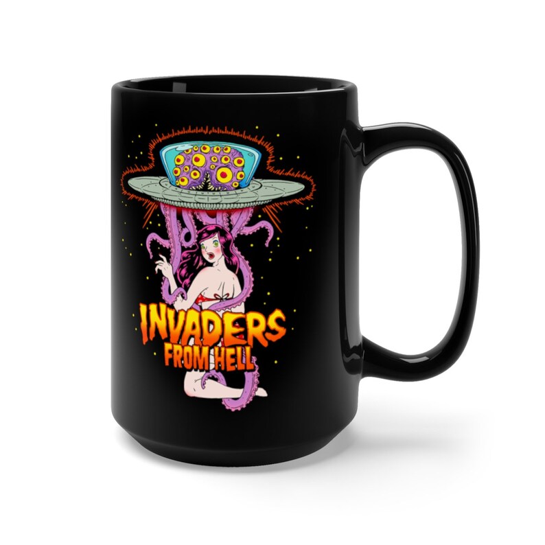 May include: Black ceramic mug with a graphic of a woman being abducted by an alien spaceship with the text "INVADERS FROM HELL".