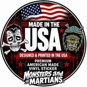 a sticker with a skull and crossbones design, along with an American flag and a monster or alien-like creature. The text on the sticker reads "MADE IN THE USA" and "DESIGNED & PRINTED IN THE USA", indicating that the sticker is made in the United States.
